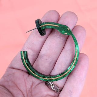 ouroborus snake hoop earrings by the bad button in green and gold